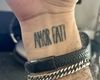 Wrist tattoo reading "Amor Fati"